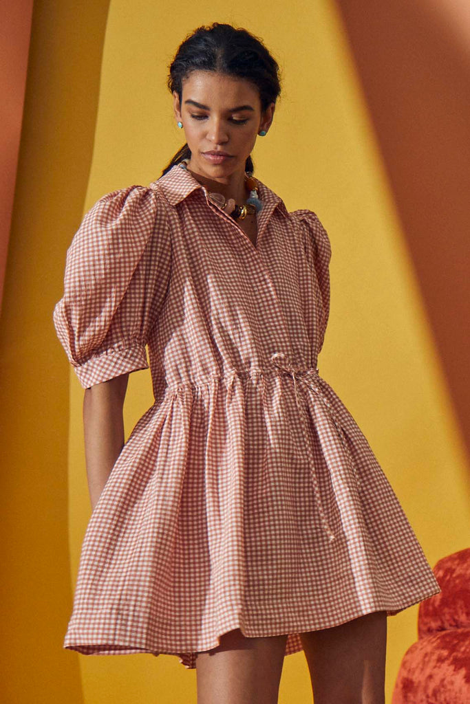 The McCauley dress features a pointed collar neckline, short puff sleeves and a drawstring waist.