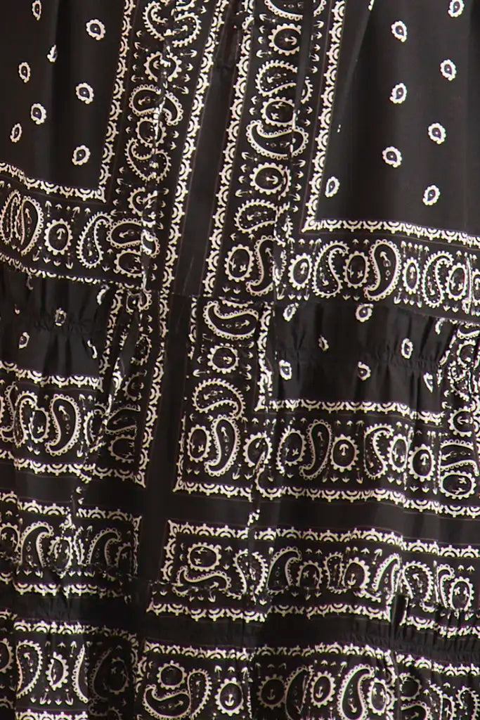 The Merritt Dress has a swing silhouette, ruffle detailing along the V-neck, and a tiered bodice.