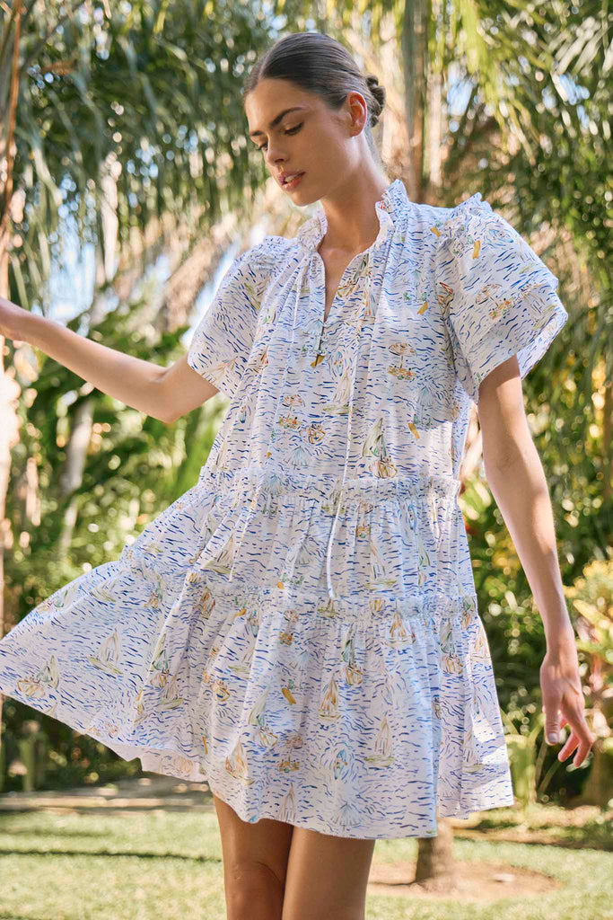The Merritt short sleeve swing dress has ruffle detailing along the v-neck and tiered bodice.