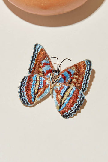These butterfly studs merge teal tones with dusty sienna, with black embroidery and seed beads.