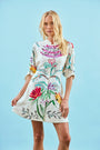 A mini dress with colorful print, front-buttons, mandarin collar, and elbow length sleeves with ties.