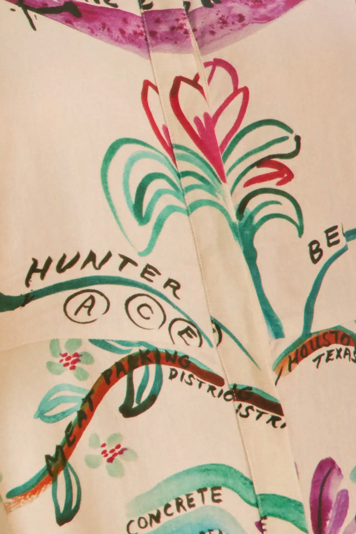 A mini dress with colorful print, front-buttons, mandarin collar, and elbow length sleeves with ties.