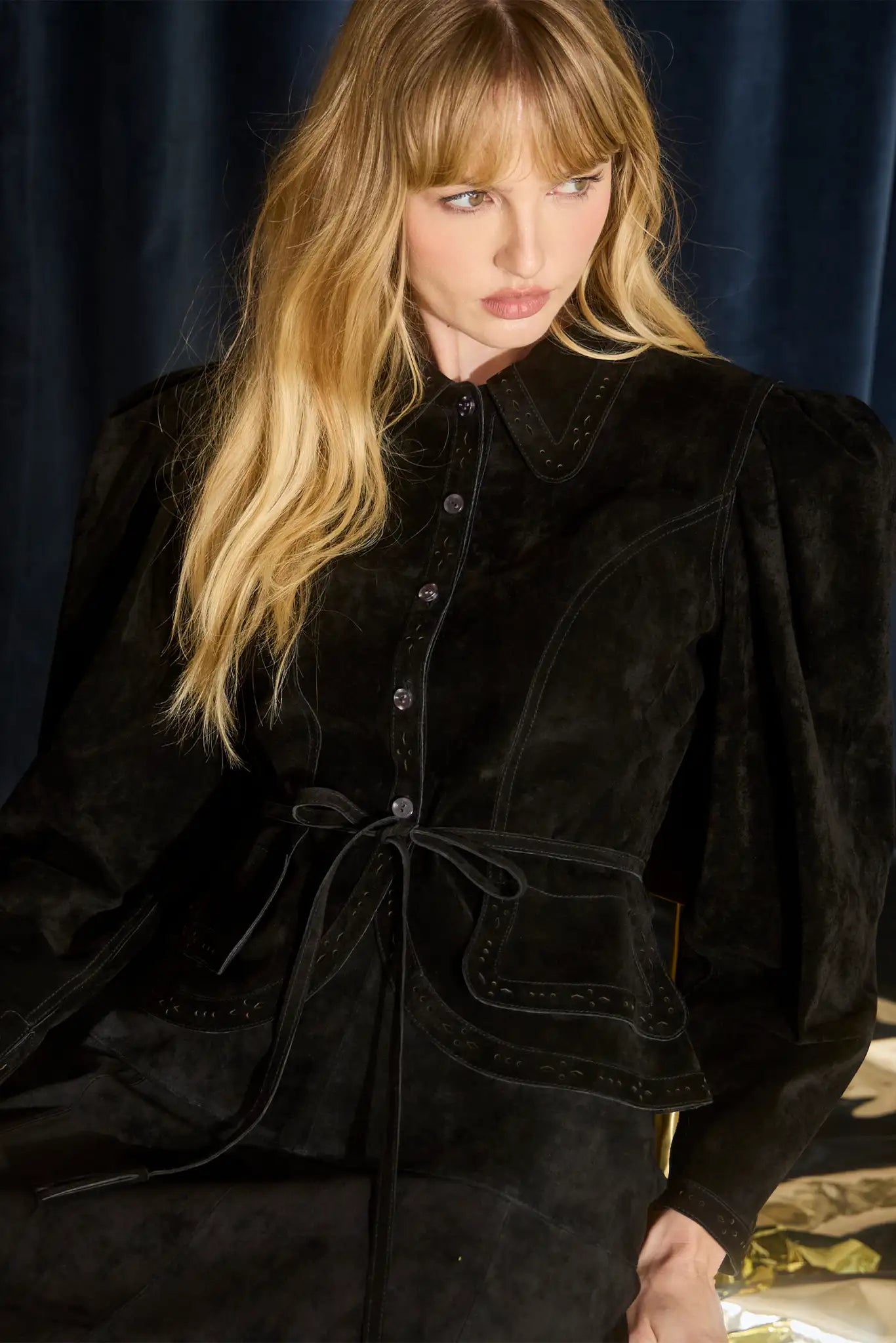 The Murphey Jacket has a button front, long sleeves with button cuffs, and a waist cinched by a belt