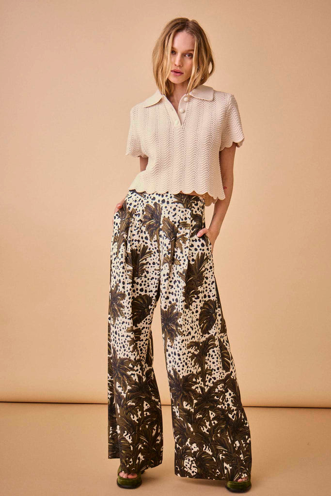 The Coston pants are high-waisted, wide-leg pants with an elastic waistband and a pleated front.