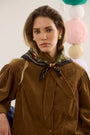 The Odessa Shirt in Khaki paired with the Suki Skirt in Found Heirloom and matching scarf. 