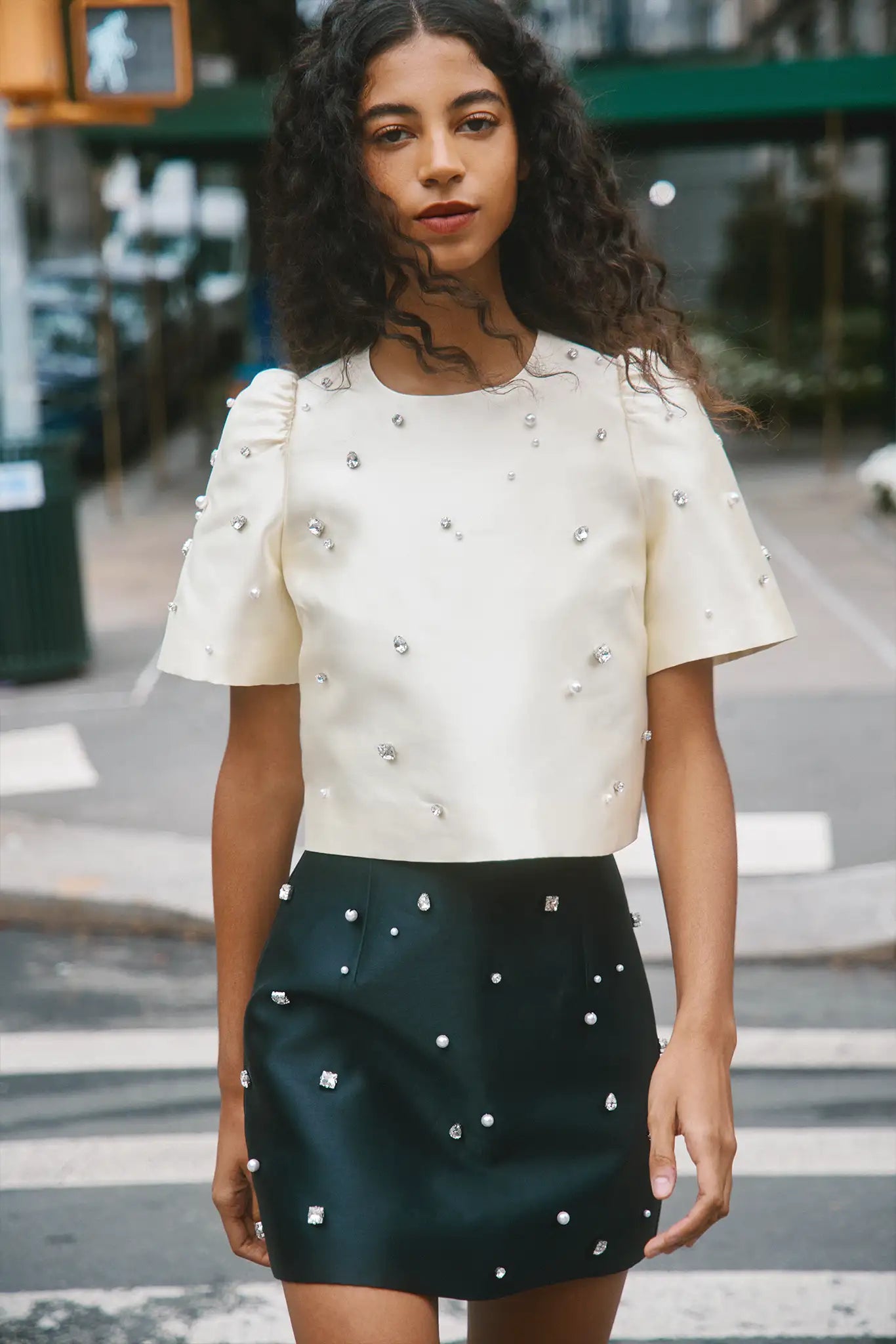 The Olivia Top is our duchess satin short-sleeve with hand-embroidered pearl-and-rhinestone detail
