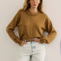 The Opal Sweater in Chestnut paired with the Wray Pant in washed blue denim. 