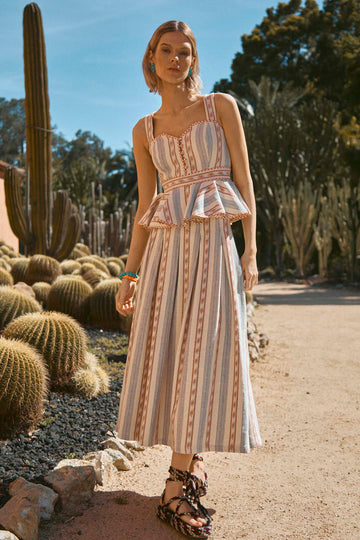 The Alexis skirt is a circle-cut skirt hits mid-calf, with a banded waist and pleating throughout.
