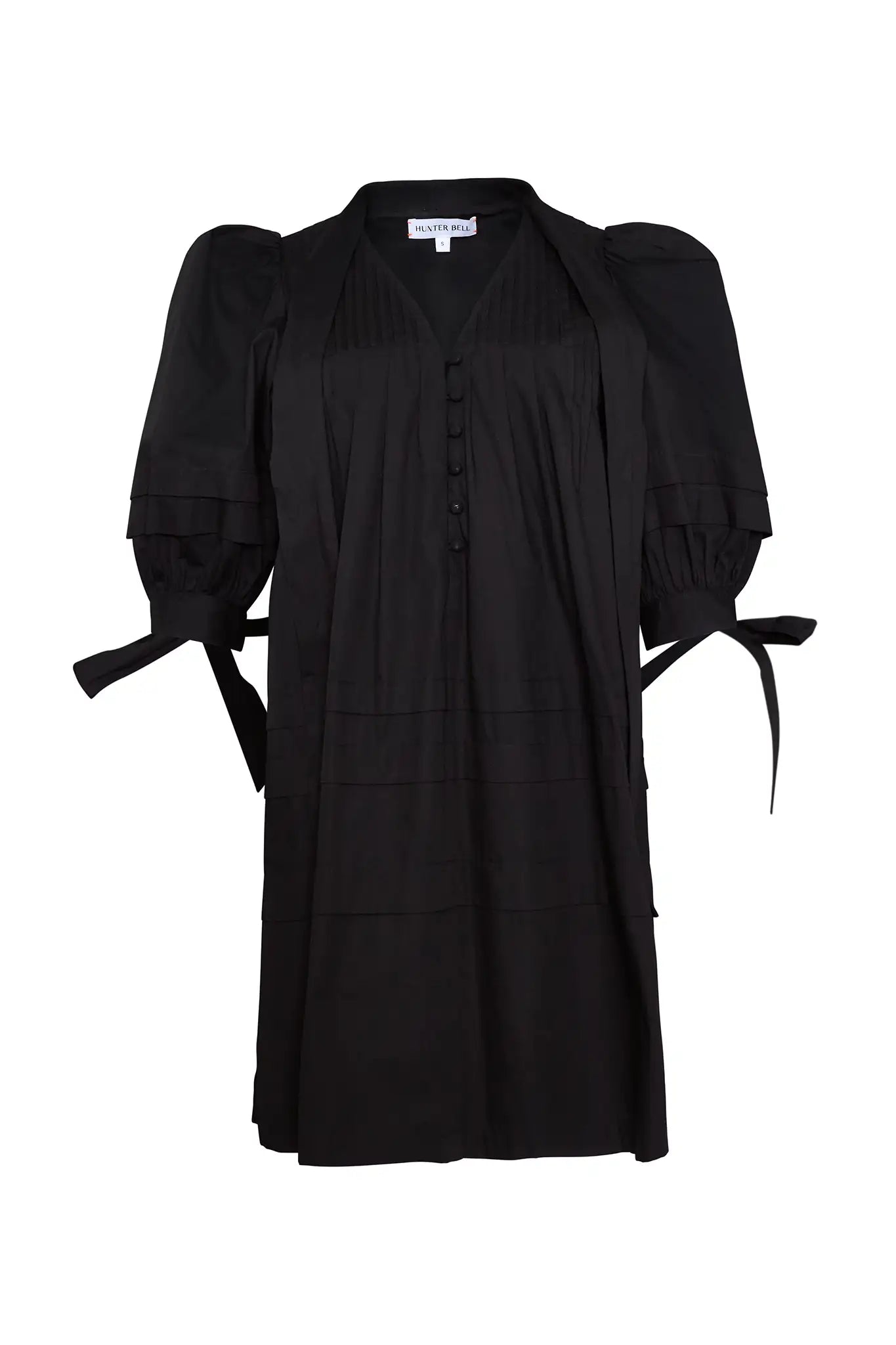 A swingy, V neck black poplin mini dress with elastic cuffs and ties with subtle pleat detailing. 