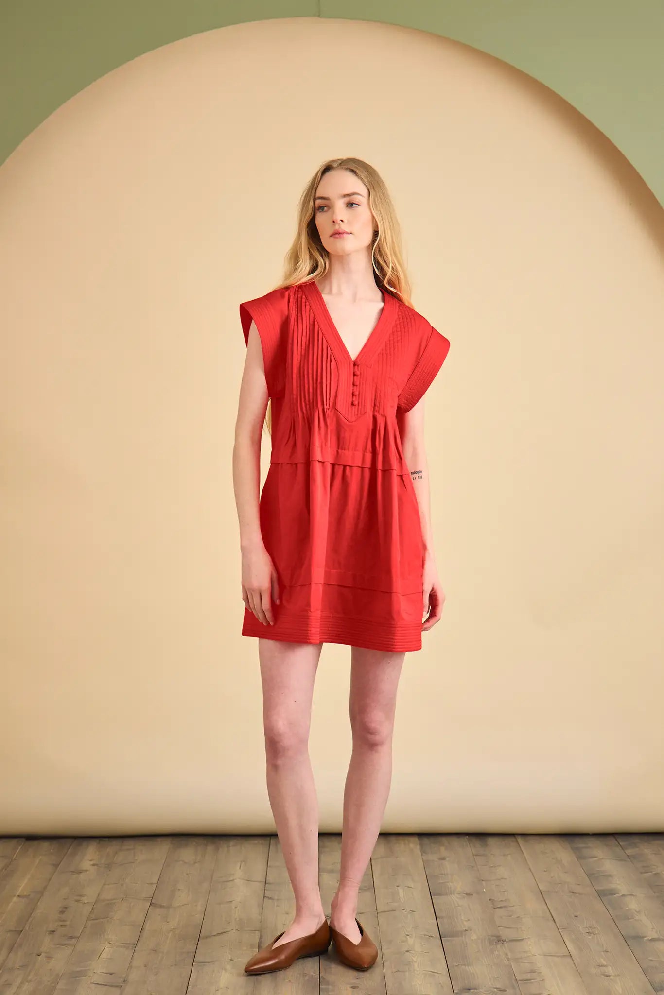 The Parker Dress has a V-neckline, front placket, banded cap sleeves, and side seam pockets.