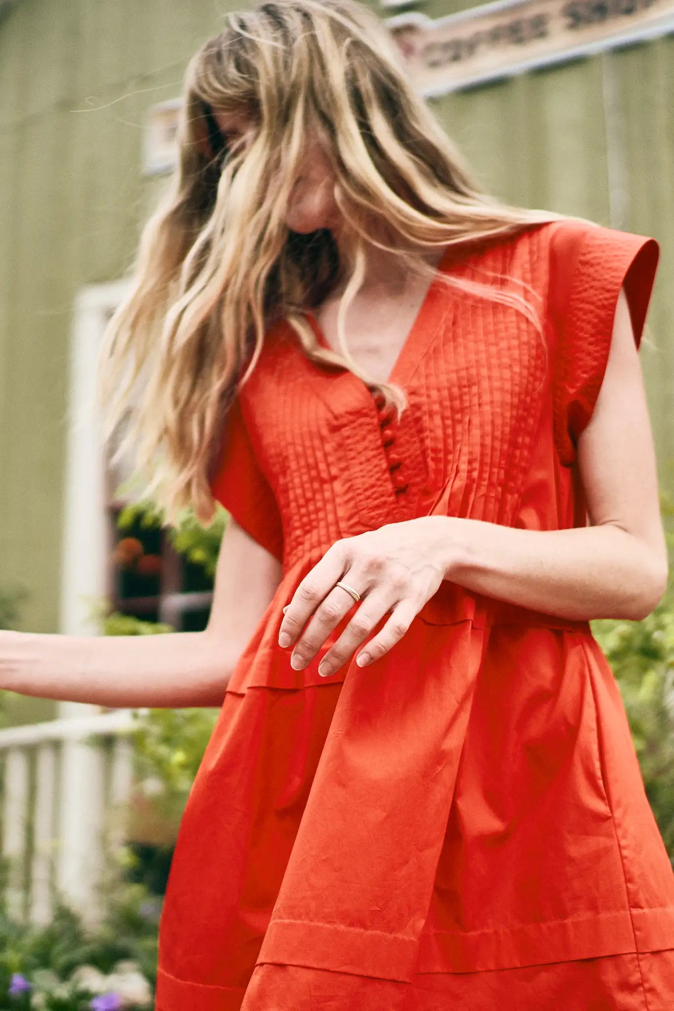 The Parker Dress has a V-neckline, front placket, banded cap sleeves, and side seam pockets.