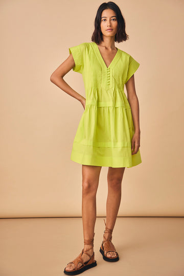 The Parker dress has a v-neckline, front placket, banded cap sleeves, and a pleated yoke.