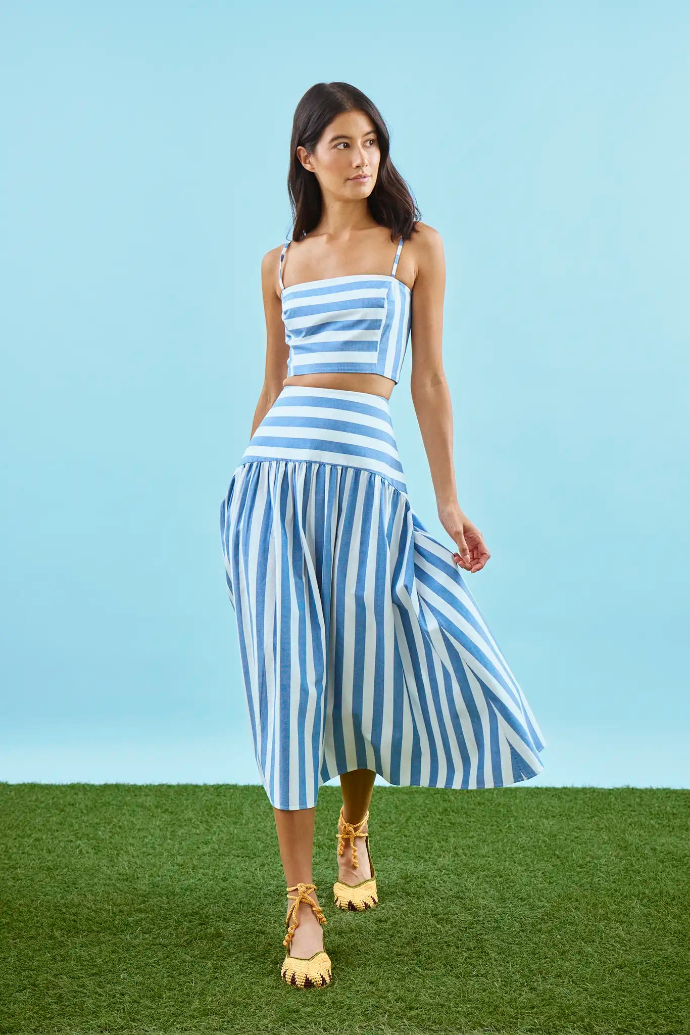 The Alyssa Midi Skirt paired with matching pepper top in blue and white stripe on model.