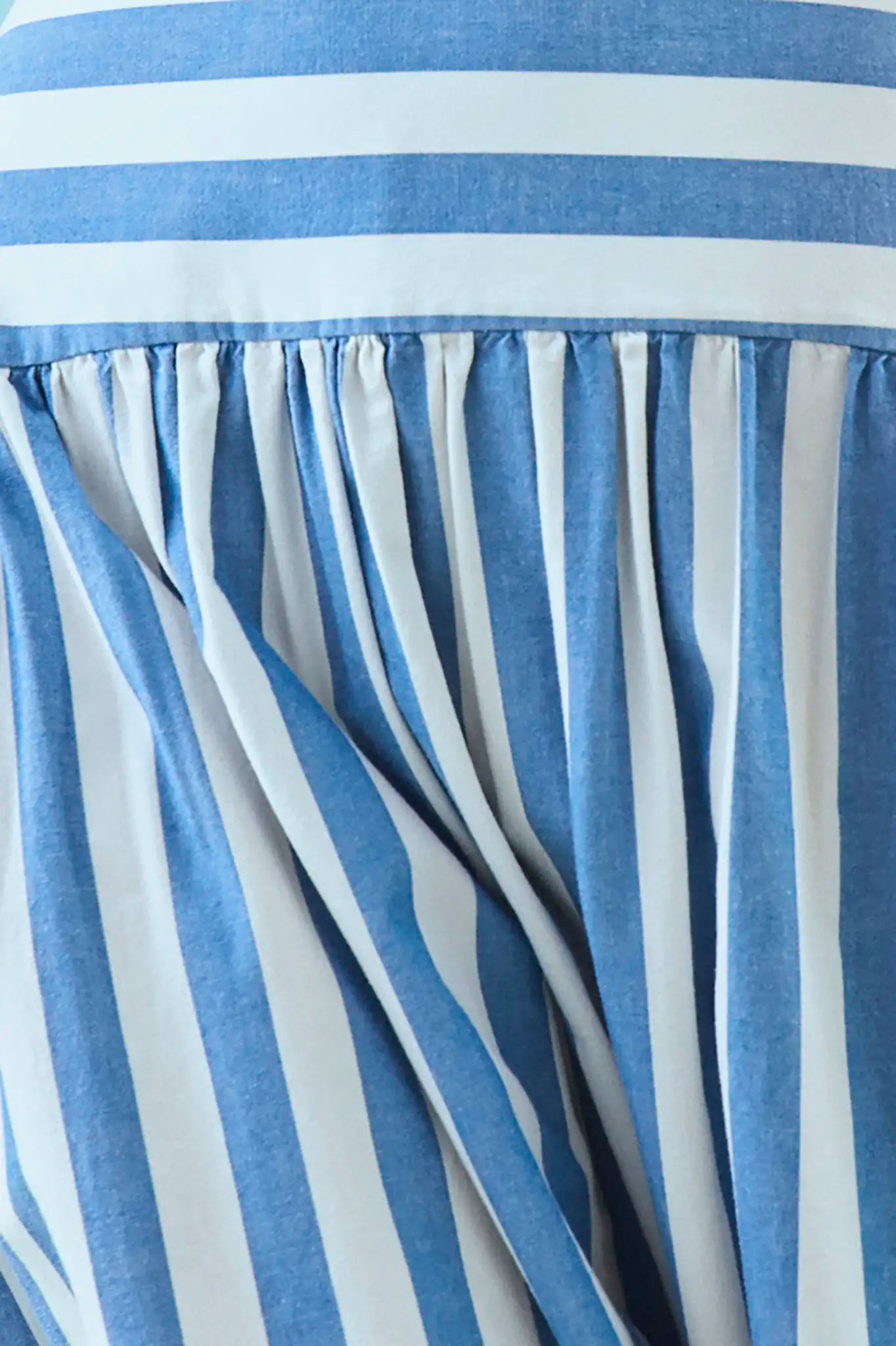 Close up of the Alyssa Midi Skirt paired with matching pepper top in blue and white stripe on model.