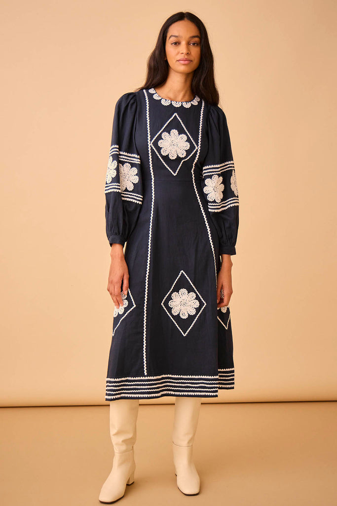 The Pimms embroidered midi dress has a crew neckline and long blouson sleeves with button cuffs.