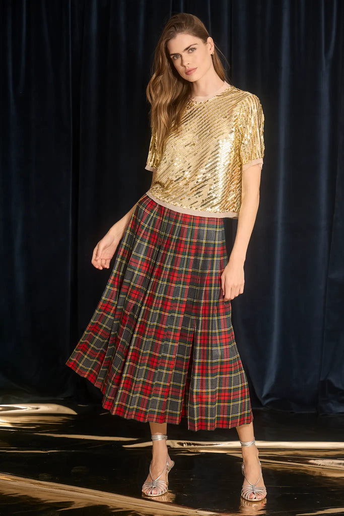 The Dominic Skirt has a banded waist and a straight pleated silhouette finished with front slits. 