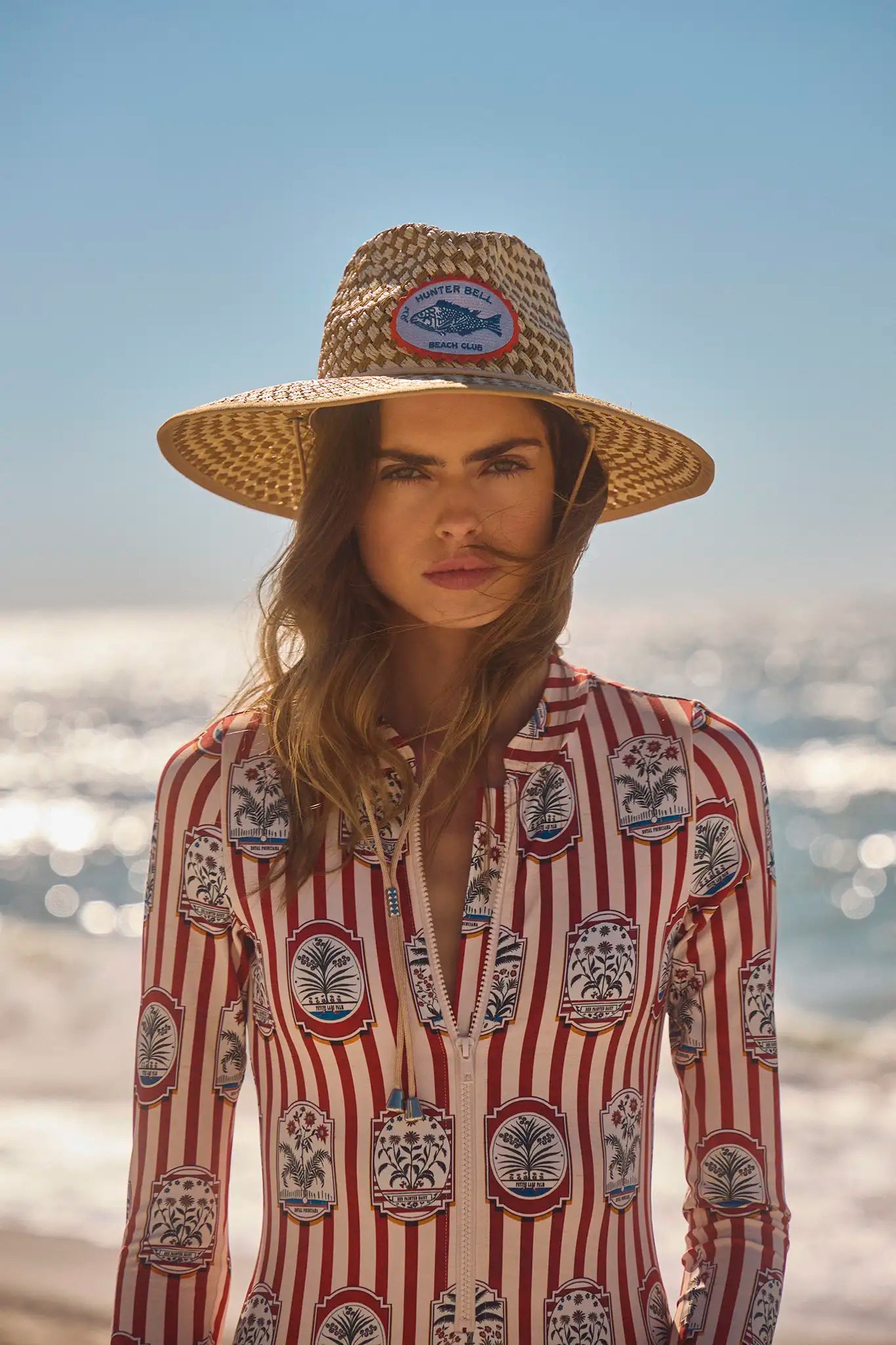 The Lifeguard Hat has a Hunter Bell logo patch and an adjustable chin strap in a sustainable straw.