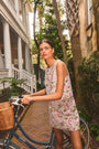 The Britt Mini Skirt in Magnolia Grove Jacquard paired with the Rebecca Top, leaning against a bike.