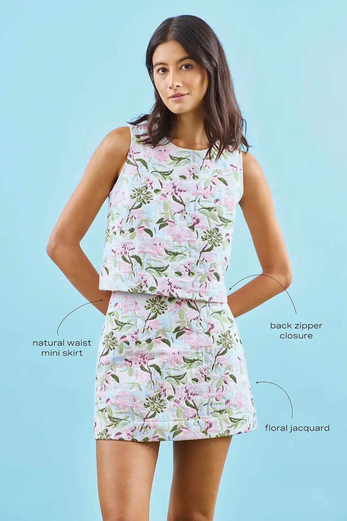 The Britt Mini Skirt in Magnolia Grove Jacquard paired with the Rebecca Top with blue background with call outs.