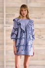 Blue cut-out embroidered linen, crew neckline, softly ruffled yoke, long sleeves with button cuffs