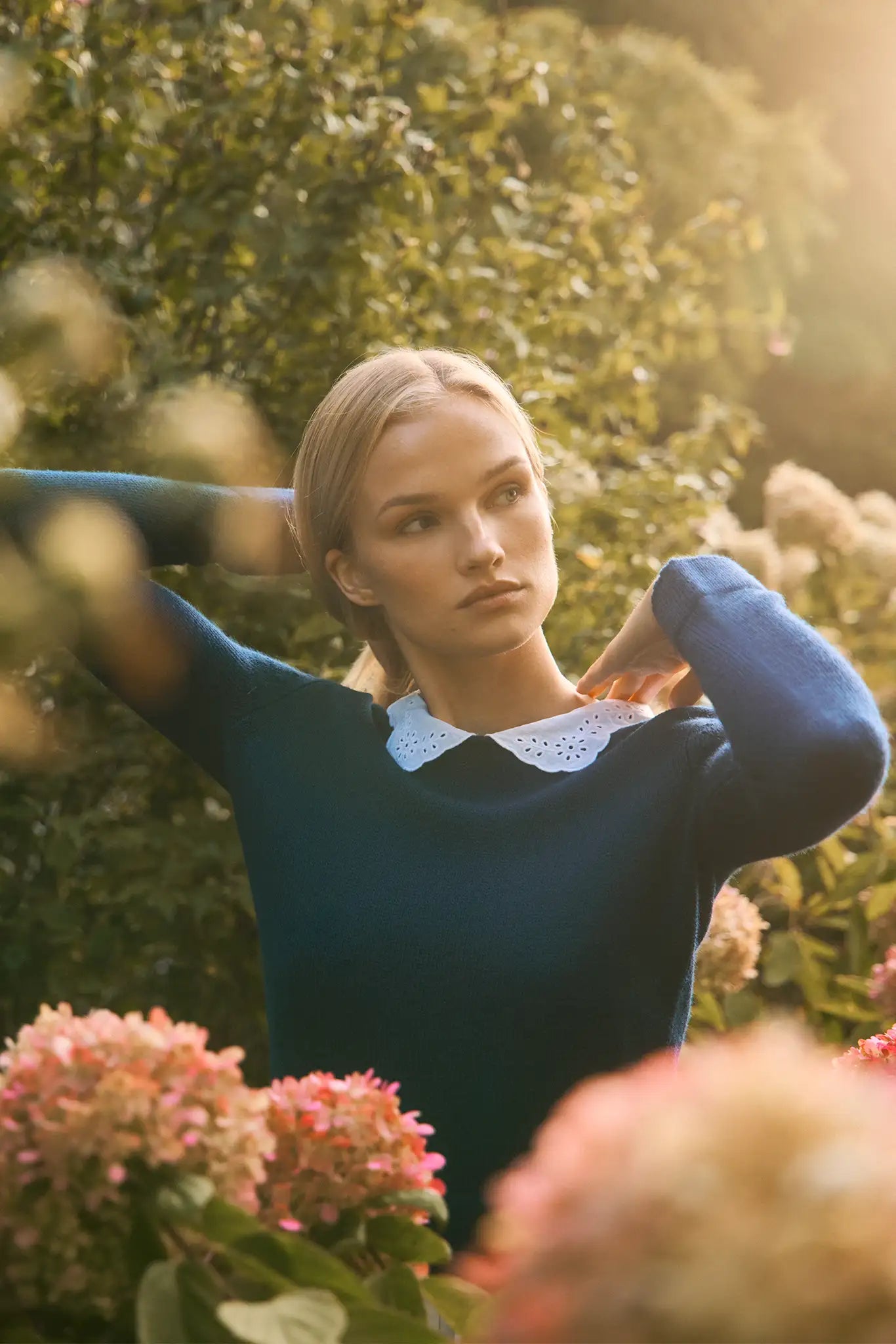 Fitted long-sleeve sweater with a delicate lace-look and eyelet-detailed collar. 