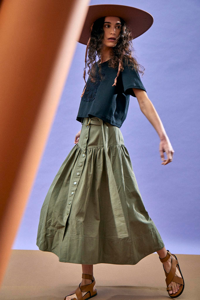 The Delaney belted midi skirt has a high hip, fitted waist, and a wide banded waist yoke.