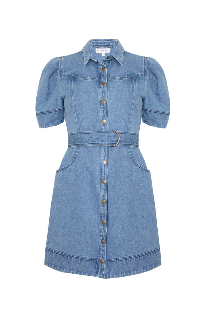 The Robinson denim dress has paneled seams, a shirttail hem, and snap a front closure.