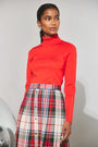 The Harlan Skirt in Kensington Crimson Plaid paired with the Roen Turtleneck in Crimson Red. 