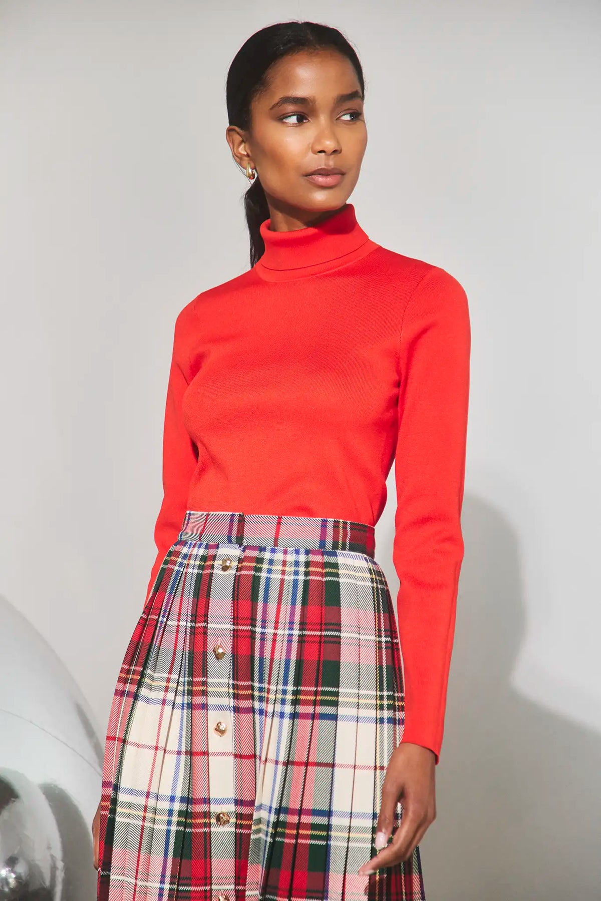 The Harlan Skirt in Kensington Crimson Plaid paired with the Roen Turtleneck in Crimson Red. 