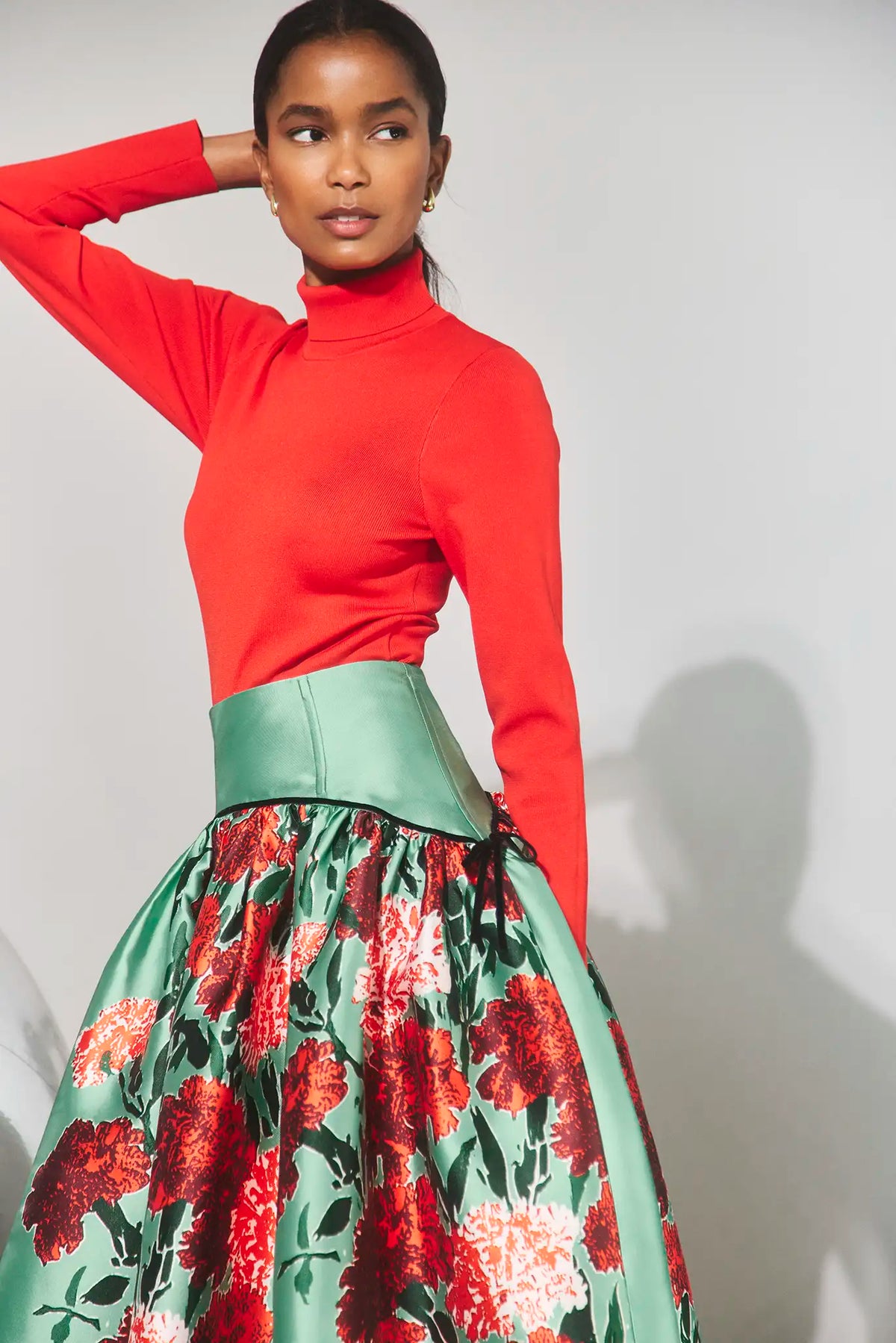 The Nolita Skirt in Evergreen Conservatory paired with the Roen Turtleneck in Crimson Red. 