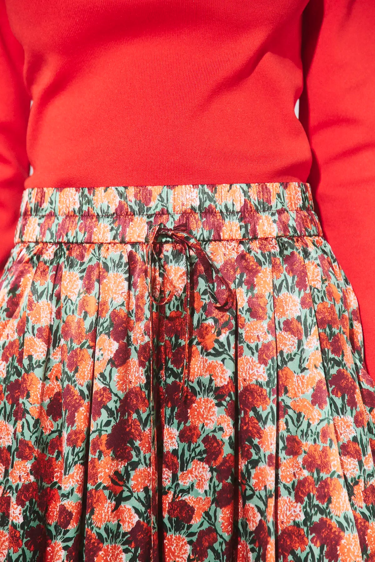 The Roen Turtleneck in Crimson Red paired with the Whisper Pant in Crimson Blossom.