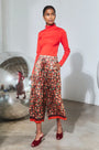 The Roen Turtleneck in Crimson Red paired with the Whisper Pant in Crimson Blossom.