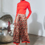 The Roen Turtleneck in Crimson Red paired with the Whisper Pant in Crimson Blossom.