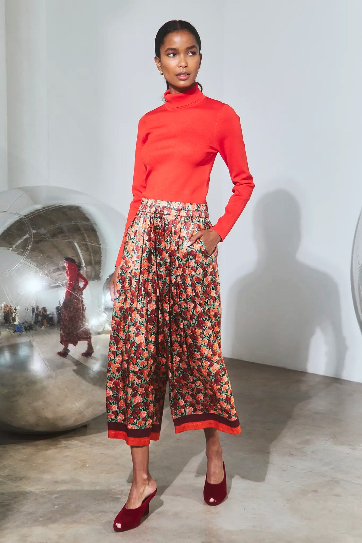 The Roen Turtleneck in Crimson Red paired with the Whisper Pant in Crimson Blossom.