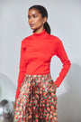 The Roen Turtleneck in Crimson Red paired with the Whisper Pant in Crimson Blossom.