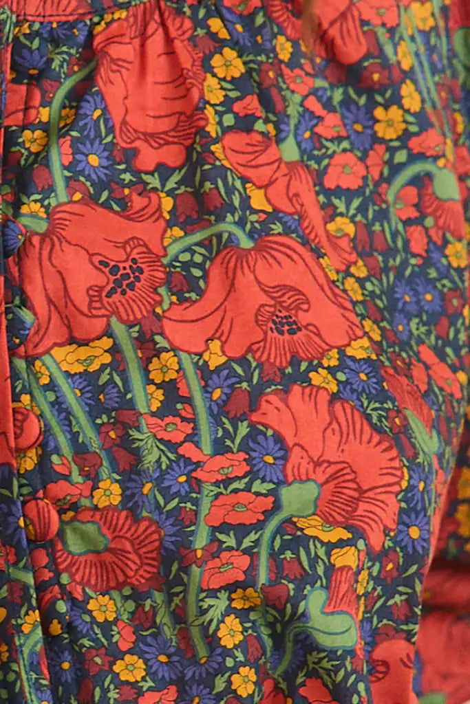 The Rory Top has a v-neckline, tie keyhole front with buttons, elbow-length sleeves with tie cuffs.