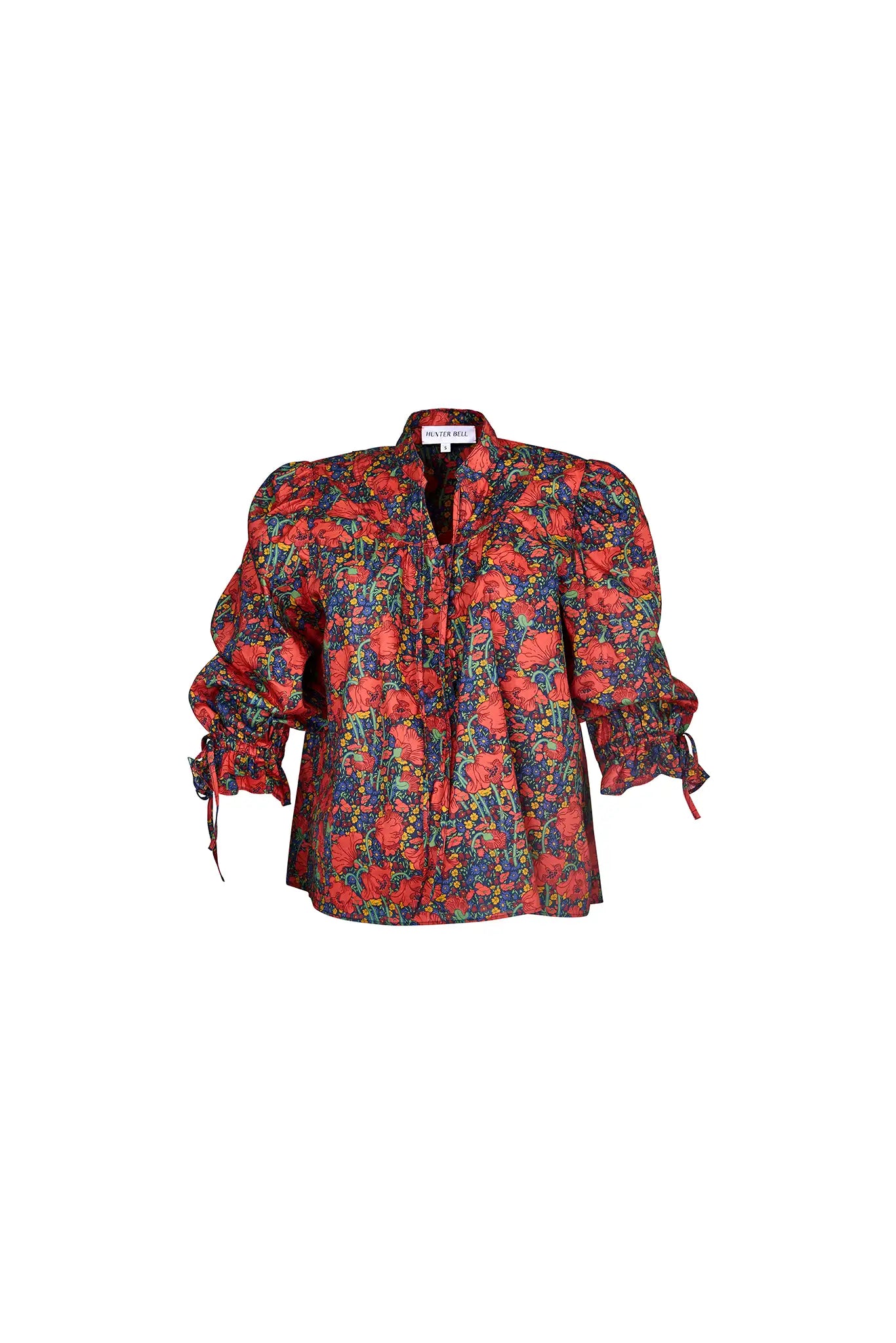 The Rory Top has a v-neckline, tie keyhole front with buttons, elbow-length sleeves with tie cuffs.