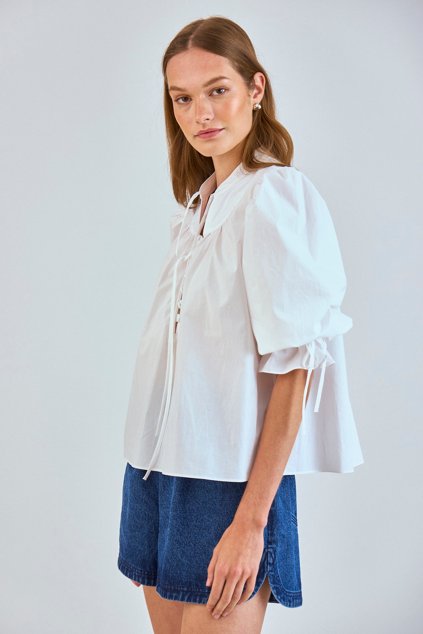 The Rory Top has a V-neck, a tie keyhole, a gathered yoke and a partial button-front placket.