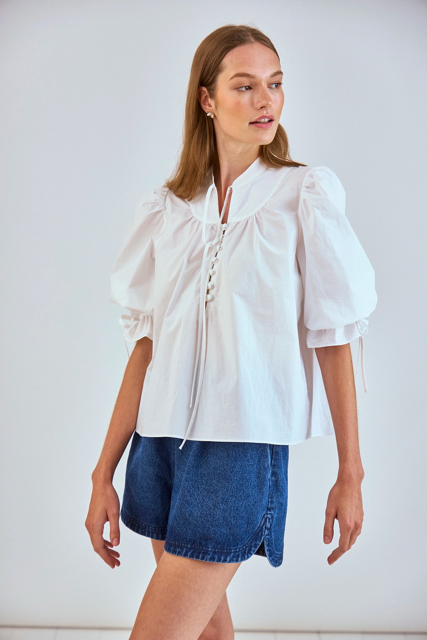 The Rory Top has a V-neck, a tie keyhole, a gathered yoke and a partial button-front placket.