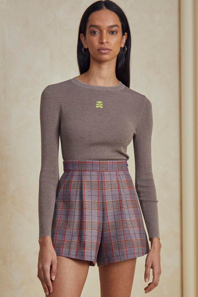 The Ashton pleated plaid shorts feature a banded waist with front pleats and an optional tie sash. 