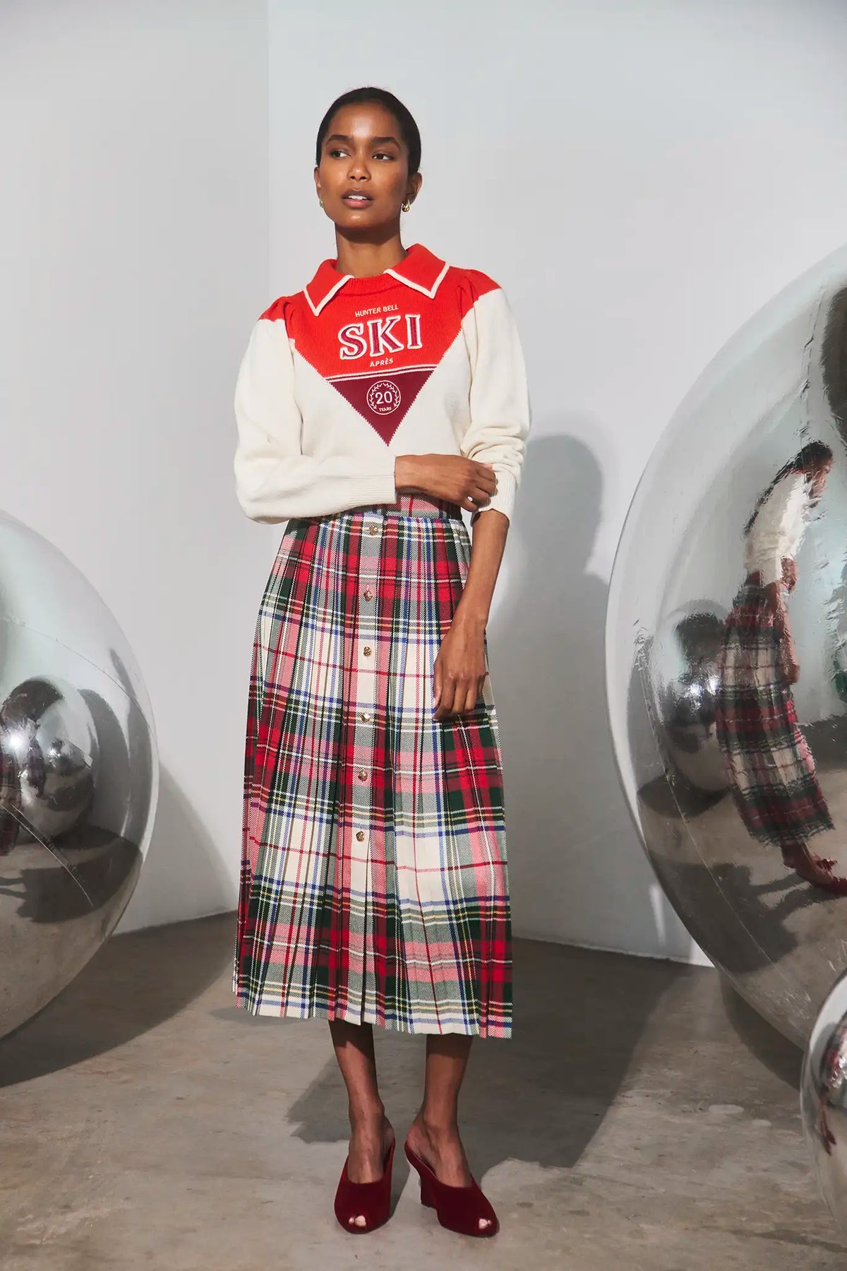The Ryder Sweater paired with the Harlan Skirt in Kensington Plaid Crimson. 