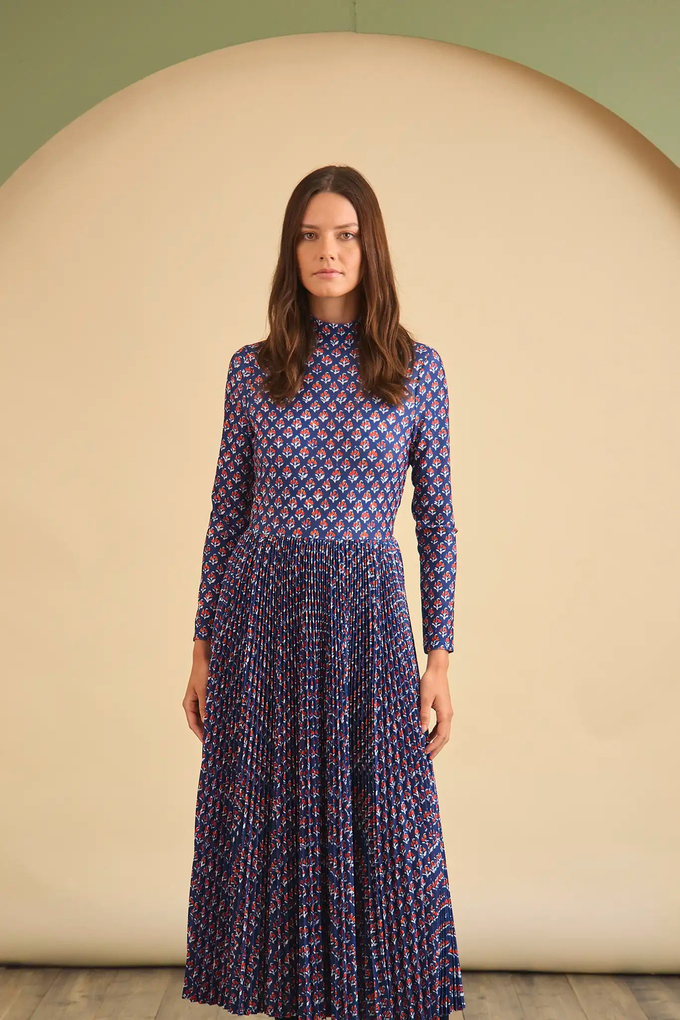 The Sabine Dress has a turtleneck top, a fitted bodice, a pleated skirt in a stretch jersey.