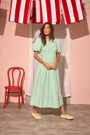 The Scarlet Dress in Saltwater paired with pale yellow shoes.