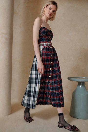 The Harlan plaid skirt has knife pleating with a banded waist and mixed plaid.