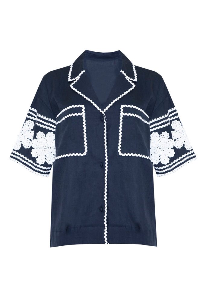 The Scout top has a boxy fit and rickrack trim along the collar, sleeves and patch front pockets.