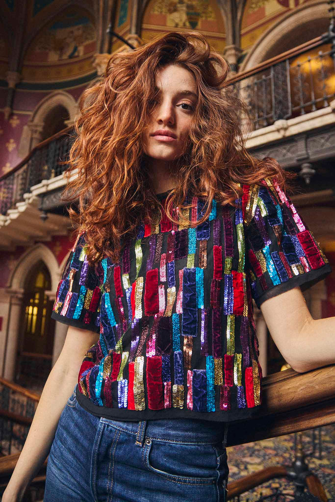 The Shelby top is hand beaded in India with padded shoulders, a crew neckline, center back zipper.