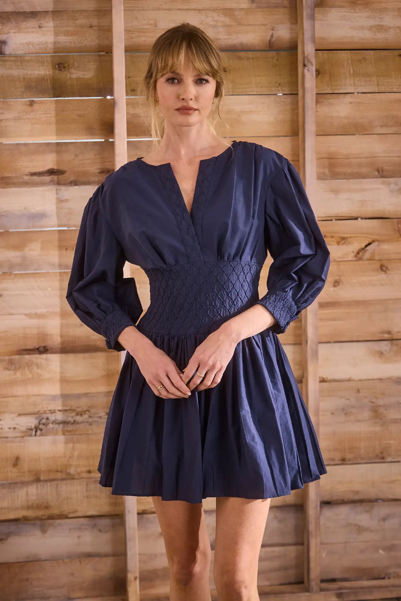 Navy diamond-smocked novelty shirting fabric with a soft V effect and blouson sleeves.