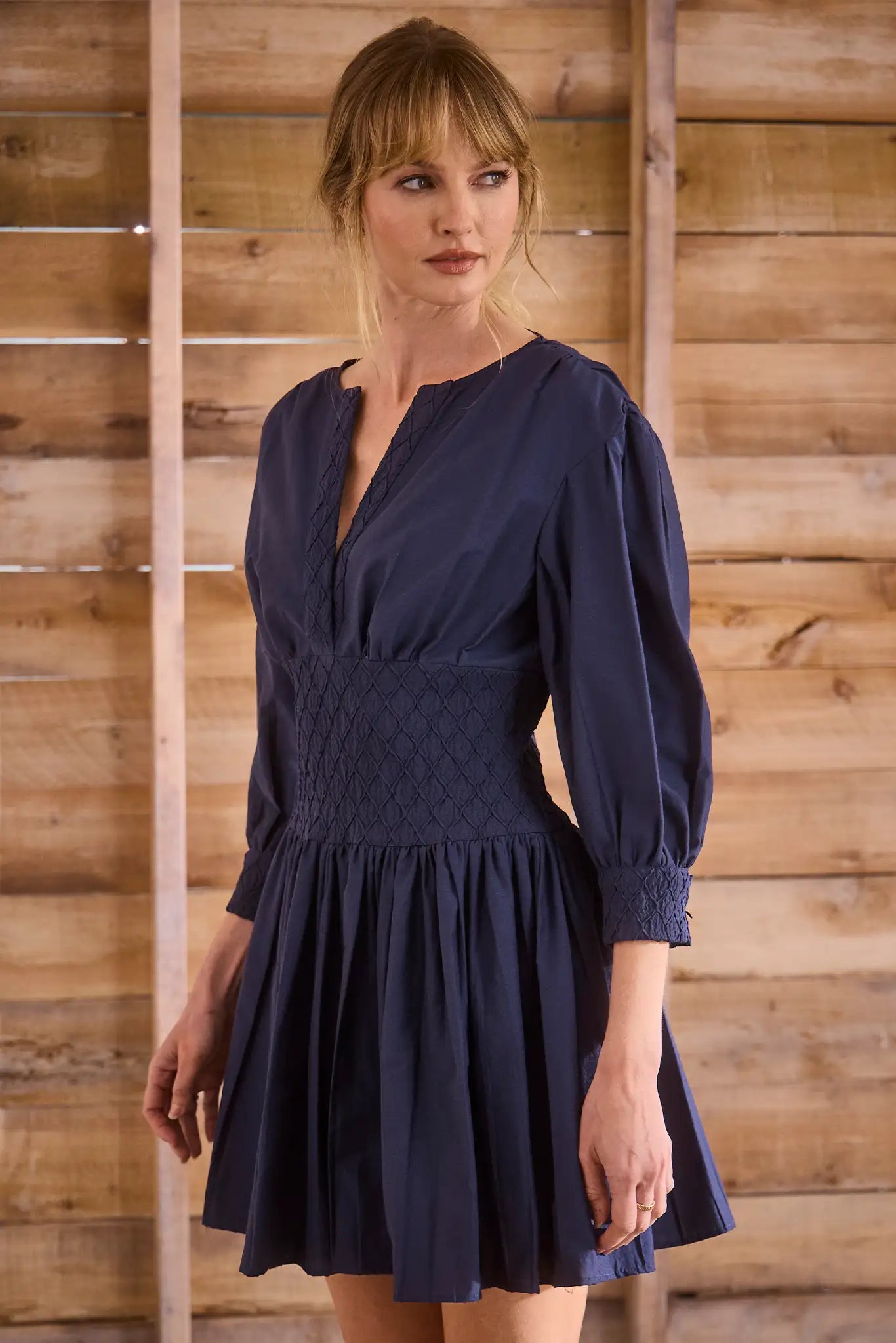 Navy diamond-smocked novelty shirting fabric with a soft V effect and blouson sleeves.