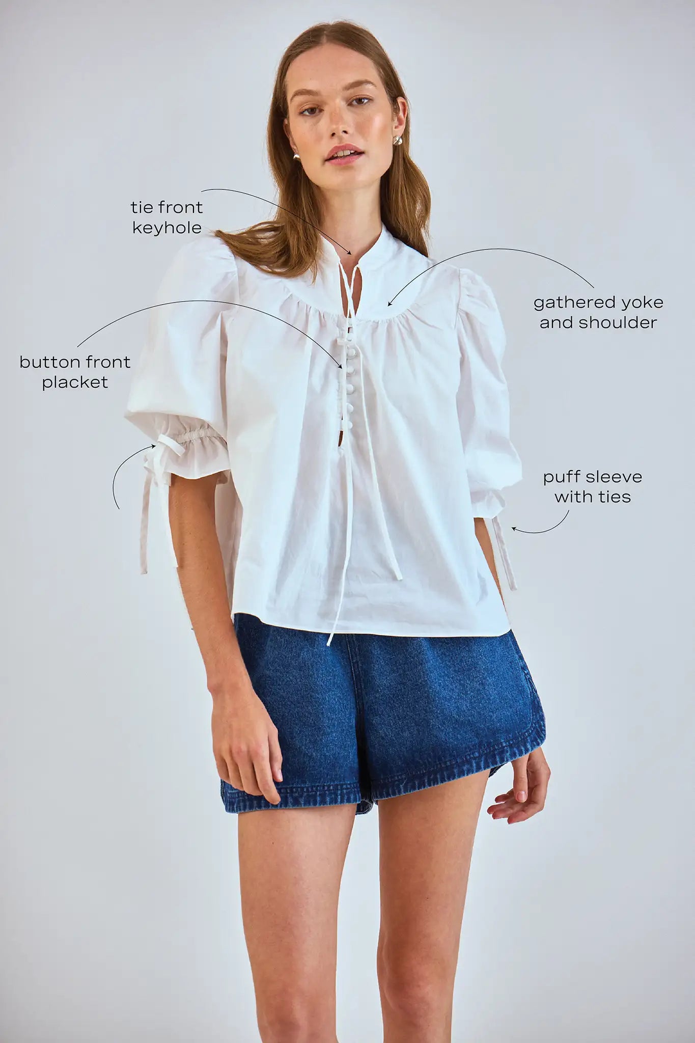 The Rory Top has a V-neck, a tie keyhole, a gathered yoke and a partial button-front placket.
