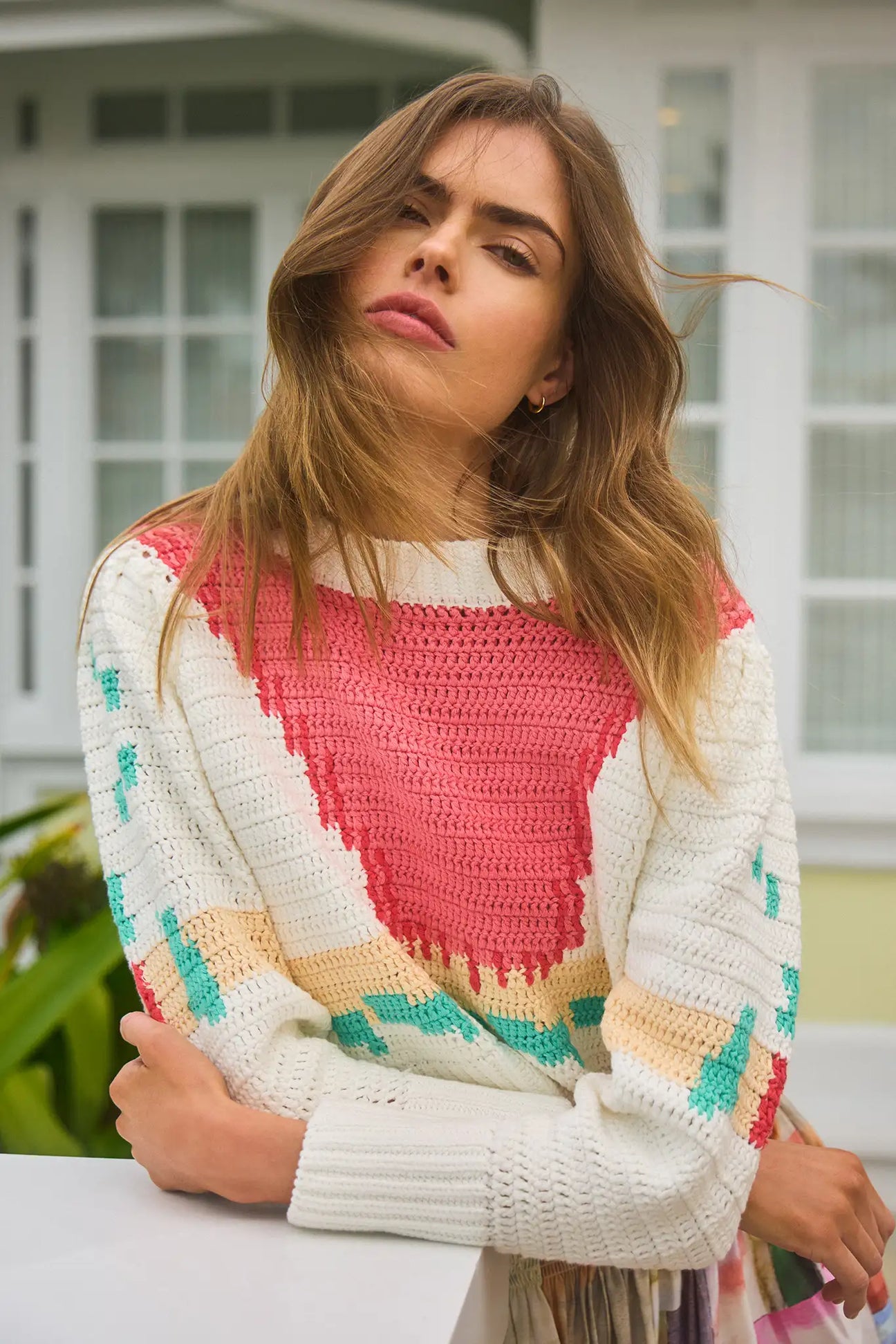 The Sully Pullover is hand-crocheted with a banded crew neck, full sleeves, and a cropped profile.